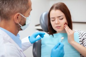 young woman in pain because of cracked teeth